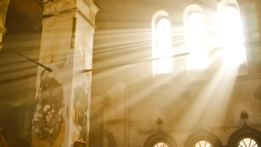 Sunlight streaming through the windows of an ancient Greek orthodox Church