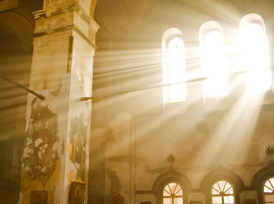 Sunlight streaming through the windows of an ancient Greek orthodox Church
